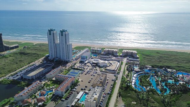 High-rise condos, vacation rental, beach-front hotels and residential neighborhood along Padre Boulevard, State Park Road 100, North Beach South Padres Island, Texas, tropical destination, aerial