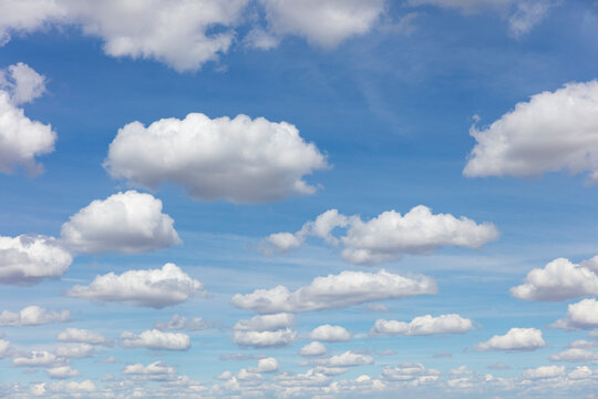 Cumulus clouds across vast blue sky