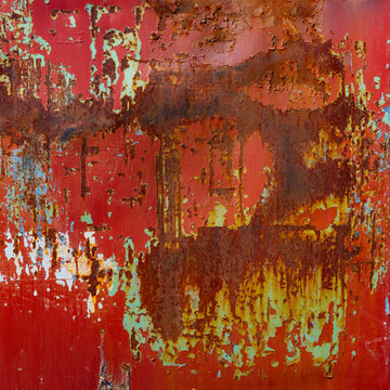 Peeling red paint and rust on metal 