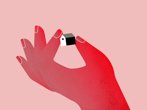 Crop red hand of woman holding small house