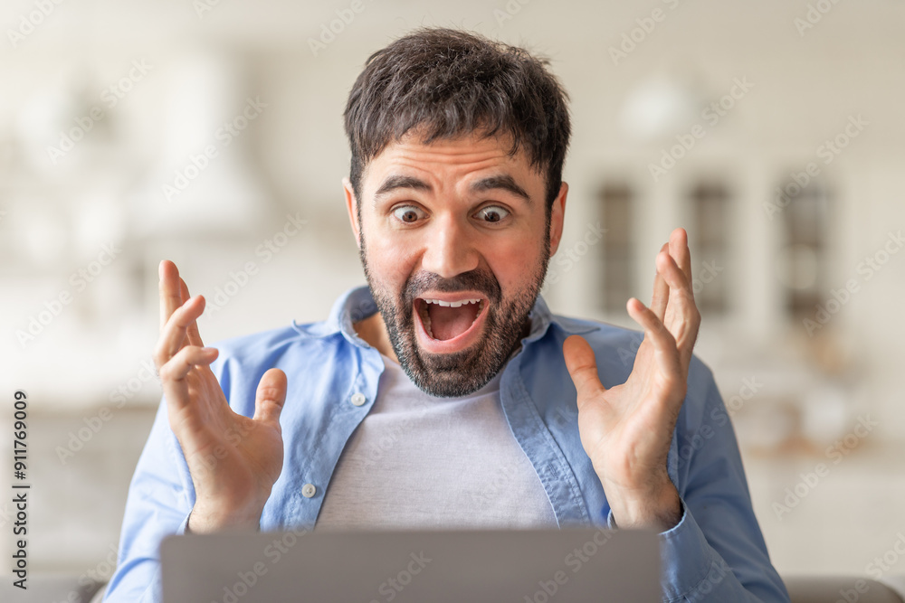 Poster A man with a surprised expression sits in front of a laptop, his hands raised in excitement as he looks at the screen.