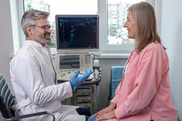 Male doctor looking confident while working with a female patient in clinic