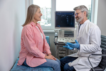 Male doctor looking confident while working with a female patient in clinic