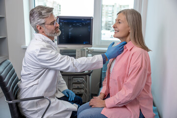 Male doctor looking confident while working with a female patient in clinic