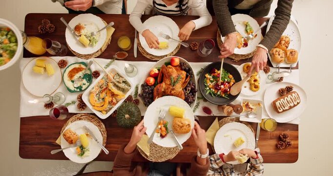 Dining table, food and hands of family at thanksgiving dinner with chicken, vegetables and juice. Meal, gathering and people at social festive event celebration for dinner, lunch or supper from above