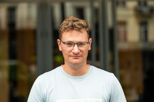 Portrait of a 45 yo white man with a city background, Brussels, Belgium
