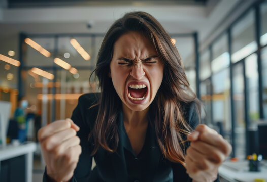 Closeup portrait of angry, frustrated woman, holding fists at camera. Negative human emotions and facial expressions