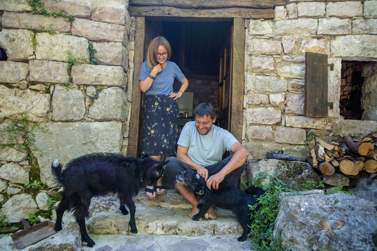 Country couple and their pets by the doorstep 