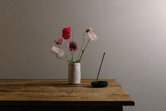 Still life of flowers, vase and incense