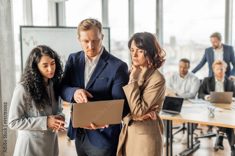 Poster a group of business professionals are gathered around a table in a modern office setting. one man ho