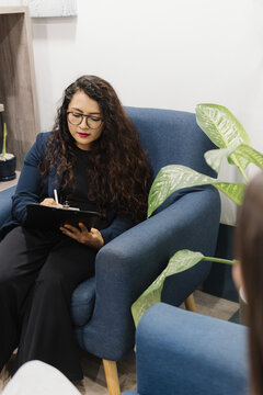 Concentrated psychologist listening to her patient.