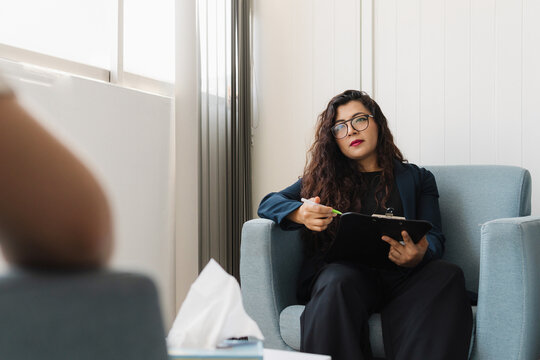 Concentrated psychologist listening to her patient.