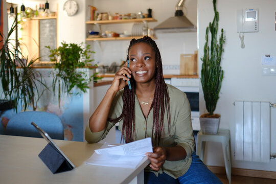 Woman at home on phone call with customer service