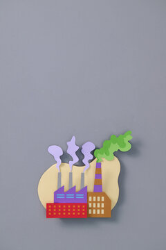 Paper Cutout of Industrial Cityscape with Smokestacks