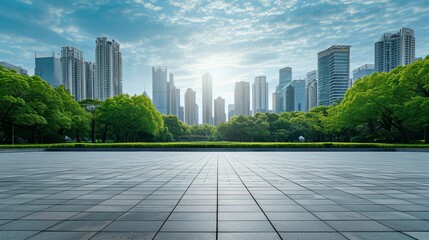 An empty square plaza with greenery and a backdrop of the city skyline and buildings.