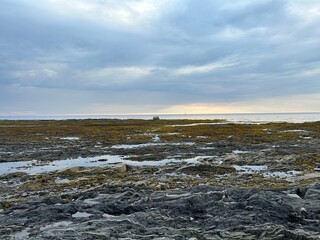 Clouds over the rocky shore