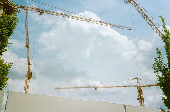 Construction cranes against the blue sky