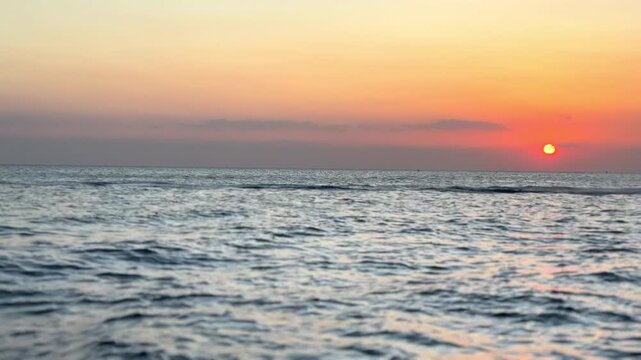 Sunset, sky and person at beach with jet ski for tropical adventure, fun activity and recreation in Zanzibar. Ripples, water sport and tourist with adrenaline in ocean for travel location or vacation