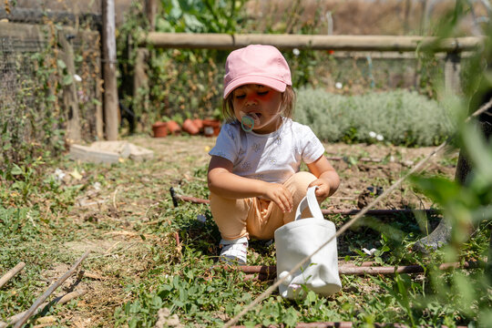 Little gardener at work in the summer garden