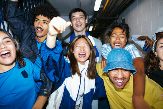 Group of friends screaming celebrating victory