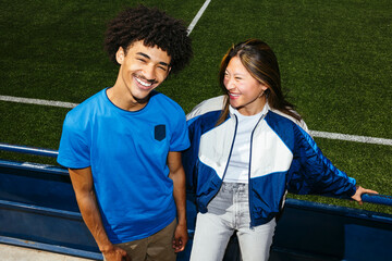 Couple laughing together outdoors at sporting event