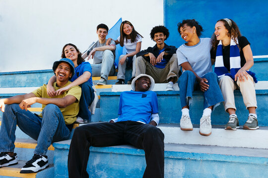 Group of friends having fun supporting their team