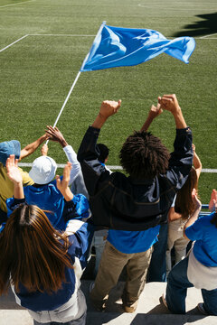Cheering fans showing team spirit at a sports game
