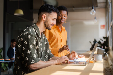 Businesspeople Working Together With Laptop In Modern Workplace