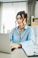 Young caucasian business woman working in office on laptop