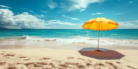 Bright yellow beach umbrella stands alone on sandy shore, clear blue ocean waves gently lap at the beach, serene summer vacation scene, copy space.
