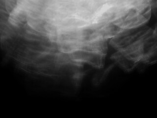 A blurry image of a light flare with a dark background. The image has a moody and mysterious feel to it. Background for design and special effects