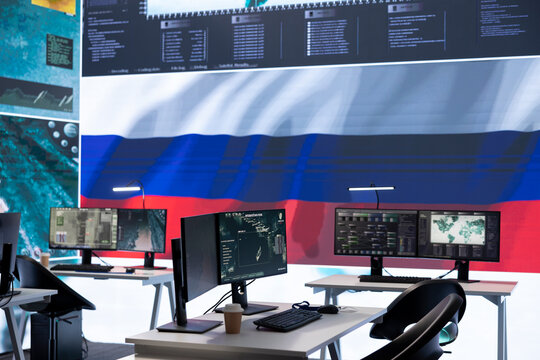 Empty russian military control center with a big screen presenting the national flag, spreading fake news and propaganda to brainwash the people. Inflicting fear among the population.