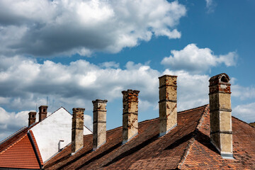 An antique house with an original preserved roof with a chimney, a historical monument
