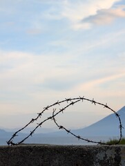 Barbed Wire Silhouette Against Serene Sky