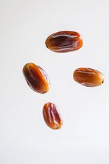 Obraz premium Ajwa Dates fruit levitating on a white background