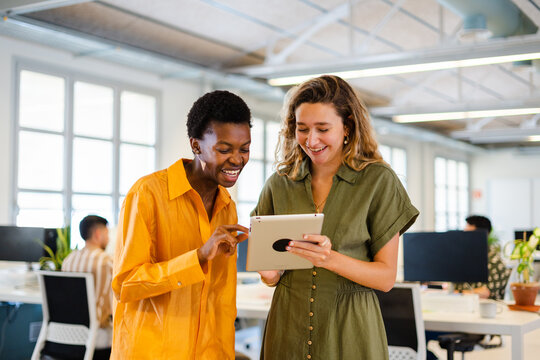 Businesswomen Using Digital Tablet In Modern Office