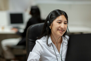 Positive Woman with headset working in call center 