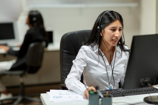 Positive Woman with headset working in call center 
