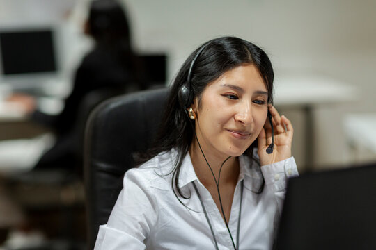 Positive Woman with headset working in call center 