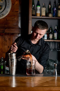 Bartender prepares cocktail at the bar counter