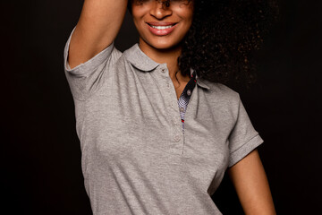 Smiling black woman wearing a gray polo shirt