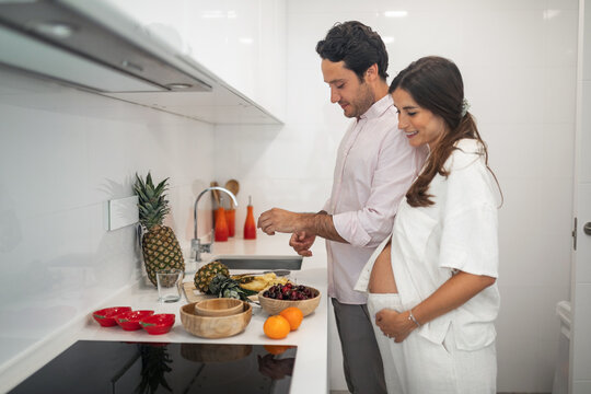 pregnant woman with husband doing daily chores at home