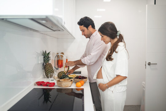 pregnant woman with husband doing daily chores at home