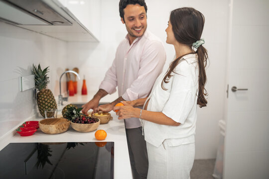 pregnant woman with husband doing daily chores at home