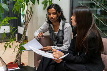 Two Businesswomen Analyzing Data In The Office.