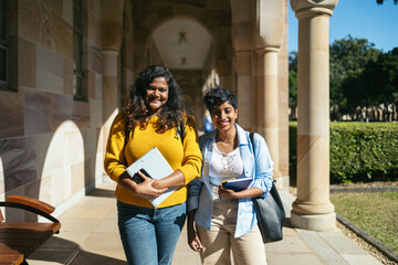 Portrait Of Two Young University Students With Backpacks