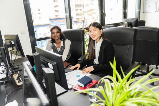 Businesswomen Working At Desk