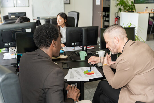 Business Discussion Over Pie Chart In Office