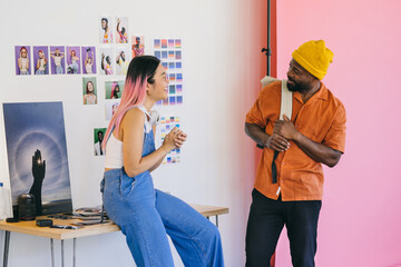 Creative colleagues enjoying a casual conversation in the studio
