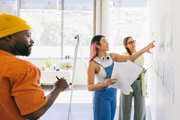 Creative multi-ethnic team brainstorming ideas in modern office space.